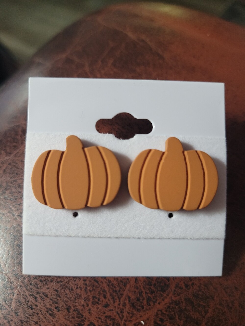 A pair of ribbed orange pumpkin lightweight matte polymer clay or resin earrings